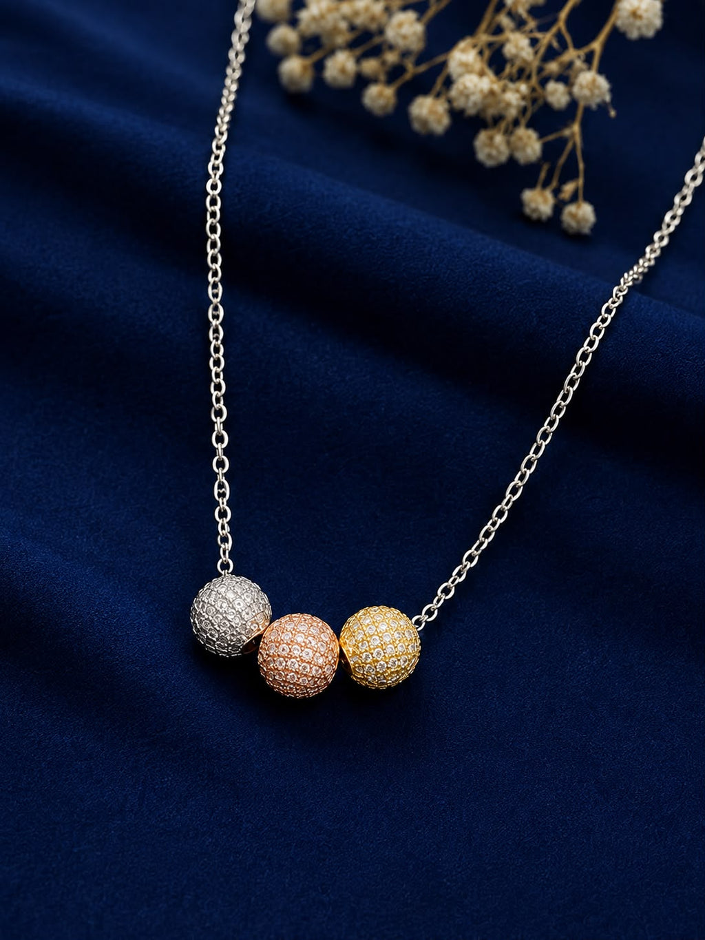 Model wearing tri-tone pavé ball necklace