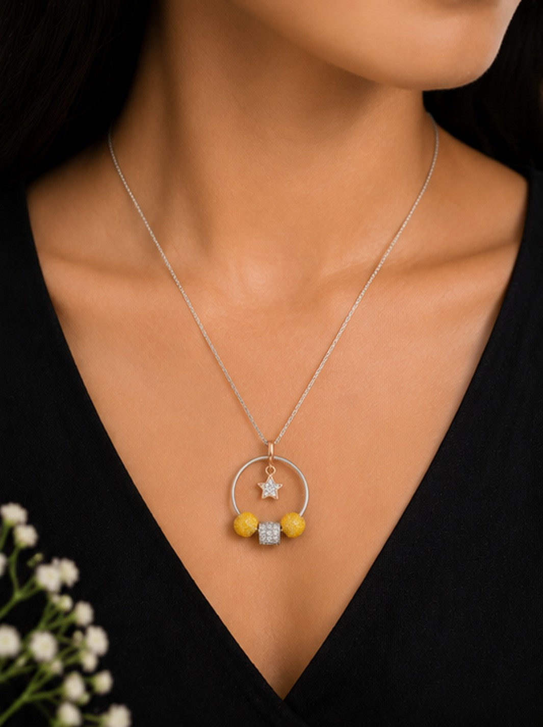 Model wearing celestial hoop star charm necklace on black top
